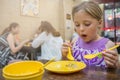 Little girl eating meal in chinese restaurant Royalty Free Stock Photo