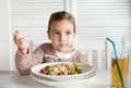 Little girl eating pasta for dinner at restaurant Royalty Free Stock Photo