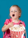 Little girl eating popcorn Royalty Free Stock Photo