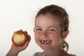 Little girl eating red apple