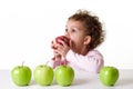 Little girl eating a red apple