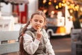 Little girl eating rench fries with sauce at street cafe outside. Concept of fast food and children Royalty Free Stock Photo
