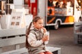 Little cute girl eating rench fries with sauce at street cafe outside. Concept of fast food and children Royalty Free Stock Photo