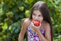 Little girl eating a slice of tomato Royalty Free Stock Photo