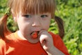 Little girl eating an strawberry Royalty Free Stock Photo