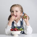 Little girl eating strawberry