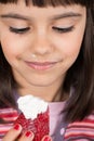 Little girl eating strawberry with cream Royalty Free Stock Photo