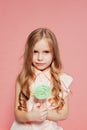 Little girl eating sweet candy lollipop on a stick Royalty Free Stock Photo