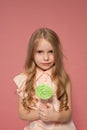 Little girl eating sweet candy lollipop on a stick Royalty Free Stock Photo