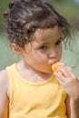 Little girl eating tangerine Royalty Free Stock Photo