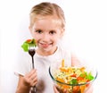 Little girl eating vegetable salad Royalty Free Stock Photo