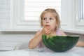 Little girl eating watermelon in the kitchen Royalty Free Stock Photo