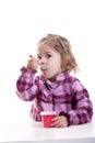 Little girl eating yogurt. Royalty Free Stock Photo