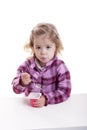 Little girl eating youghurt.