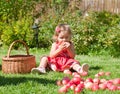 Little girl eats an apple