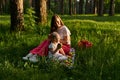 Little girl eats an apple in nature during a picnic with her mom Royalty Free Stock Photo