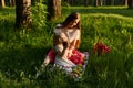 Little girl eats an apple in nature during a picnic with her mom Royalty Free Stock Photo