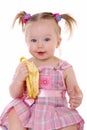 Little girl eats banana