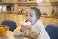 Little girl eats cake Anna Pavlova