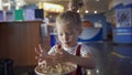 Little girl eats popcorn in movie theater. Media. Cute girl eating popcorn in waiting room at cinema. Pretty girl cute