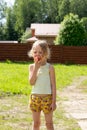 Little girl eats red apple outdoor Royalty Free Stock Photo