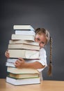 Little girl embraces a pile of books