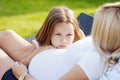 Little girl embraces a stomach of pregnant mother. Serious and thoughtful look Royalty Free Stock Photo