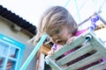 Little girl emotionally swing outdoor portrait with come uncurled hairs, child playing Royalty Free Stock Photo