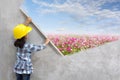 Little girl engineering with painting flowers grass on wall Royalty Free Stock Photo