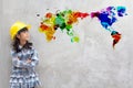 Little girl engineering with watercolor world map