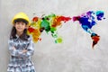 Little girl engineering with watercolor world map