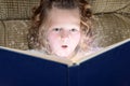 Little girl enjoying magic of reading