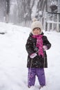 Little girl enjoying a sleigh ride. Child sledding. Children play outdoors in snow Royalty Free Stock Photo