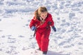 Little girl enjoying a sleigh ride in winter. Children play outdoors in snow. Outdoor fun, Christmas vacation. Happy Royalty Free Stock Photo