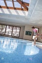 Little girl enjoying swimming pool indoors Royalty Free Stock Photo