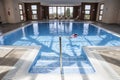 Little girl enjoying swimming pool indoors Royalty Free Stock Photo