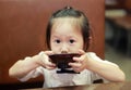 Little girl enjoys eating miso soup at japanese restaurant Royalty Free Stock Photo