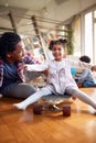 A little girl enjoys father riding her on the skateboard at home. Family, together, love, playtime