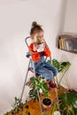 Little girl enjoys a grown cactus. Royalty Free Stock Photo