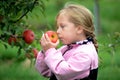 Little girl enjoys the sweet aroma of an apple
