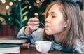 A little girl enjoys tea while sitting in a cafe. Royalty Free Stock Photo