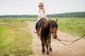 Little girl in equestrian helmet riding a horse Royalty Free Stock Photo