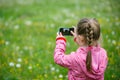 Little girl exploring nature with her smartphone Royalty Free Stock Photo
