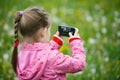 Little girl exploring nature with her smartphone Royalty Free Stock Photo