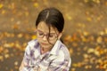 Little girl with eyeglasses in the autumn park. Selective focus Royalty Free Stock Photo