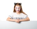 Little girl with face art holding a sheet for your adverisement or text isolated Royalty Free Stock Photo