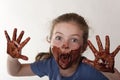 Little girl face covered in chocolate