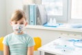 Little girl in face mask in doctor`s office is vaccinated. Syringe with vaccine for covid-19 coronavirus,flu,dangerous infectious Royalty Free Stock Photo