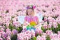 Little girl in fairy costume playing in flower field Royalty Free Stock Photo