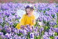 Little girl in fairy costume playing in flower field Royalty Free Stock Photo